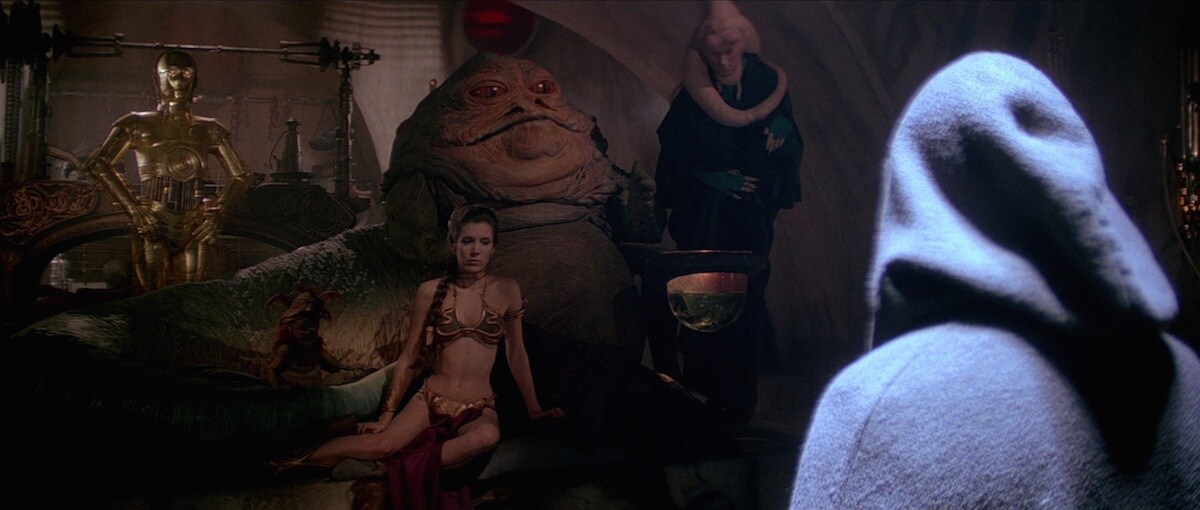 Bib Fortuna beside Jabba the Hutt as he addresses Luke Skywalker