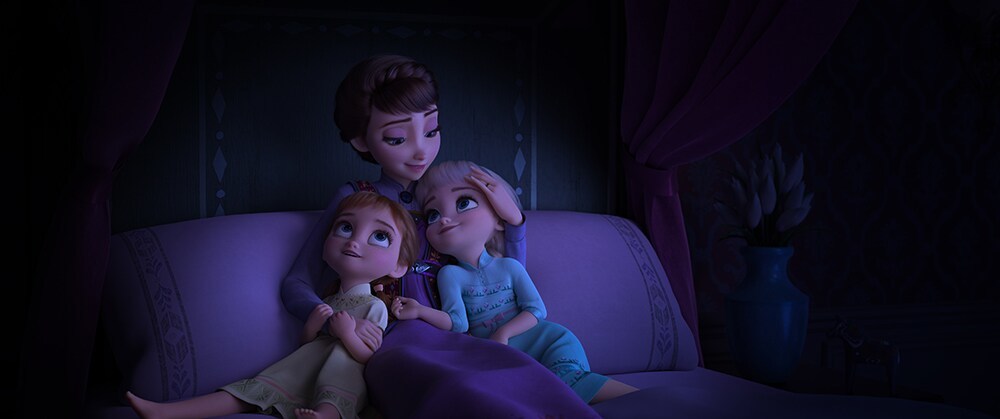 Queen Iduna, Anna and Elsa's mother, hugging young Anna and Elsa 