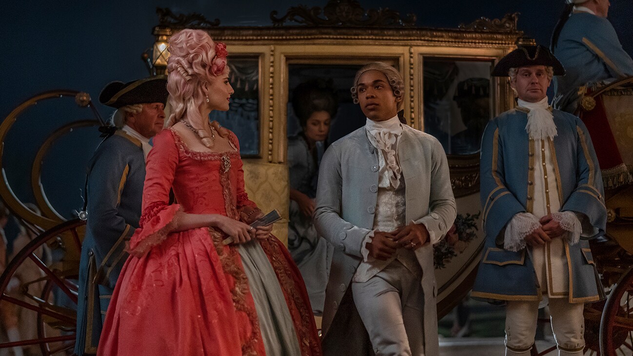  Marie Antoinette (actor Lucy Boynton) and Joseph (actor Kelvin Harrison Jr.) in front of a carriage in the 20th Century Studios movie, "Chevalier."