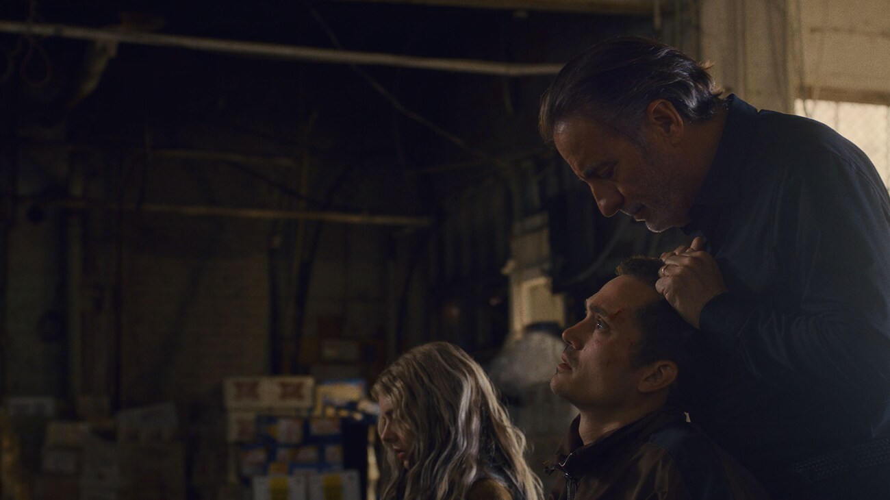 Edie (Samara Weaving) and John (Karl Glusman) with Nico (Andy Garcia) scene from 20th Century Studios' EENIE MEANIE. Photo courtesy of 20th Century Studios. © 2025 20th Century Studios. All Rights Reserved.