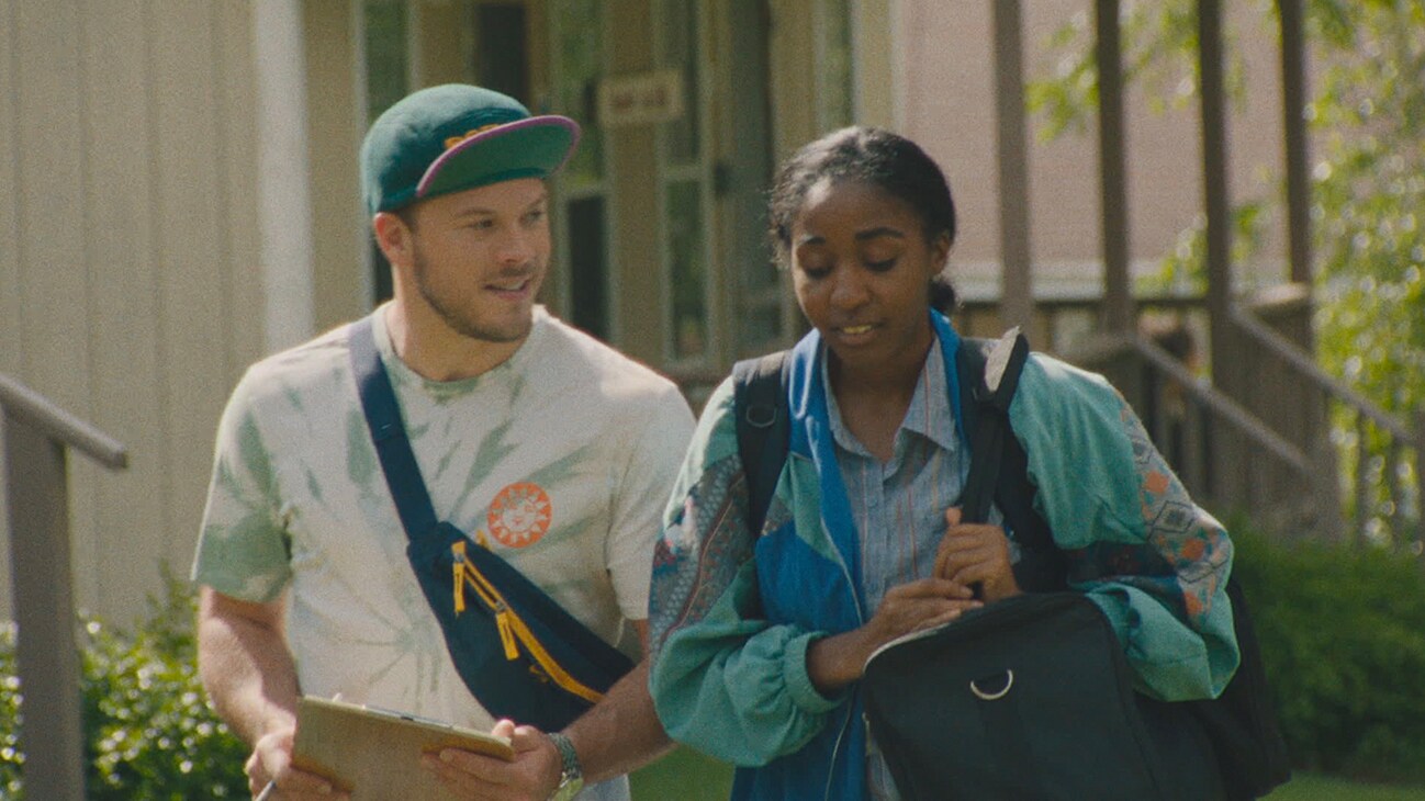 Jimmy Tatro and Ayo Edebiri walking together from the Searchlight Pictures movie, "Theater Camp."