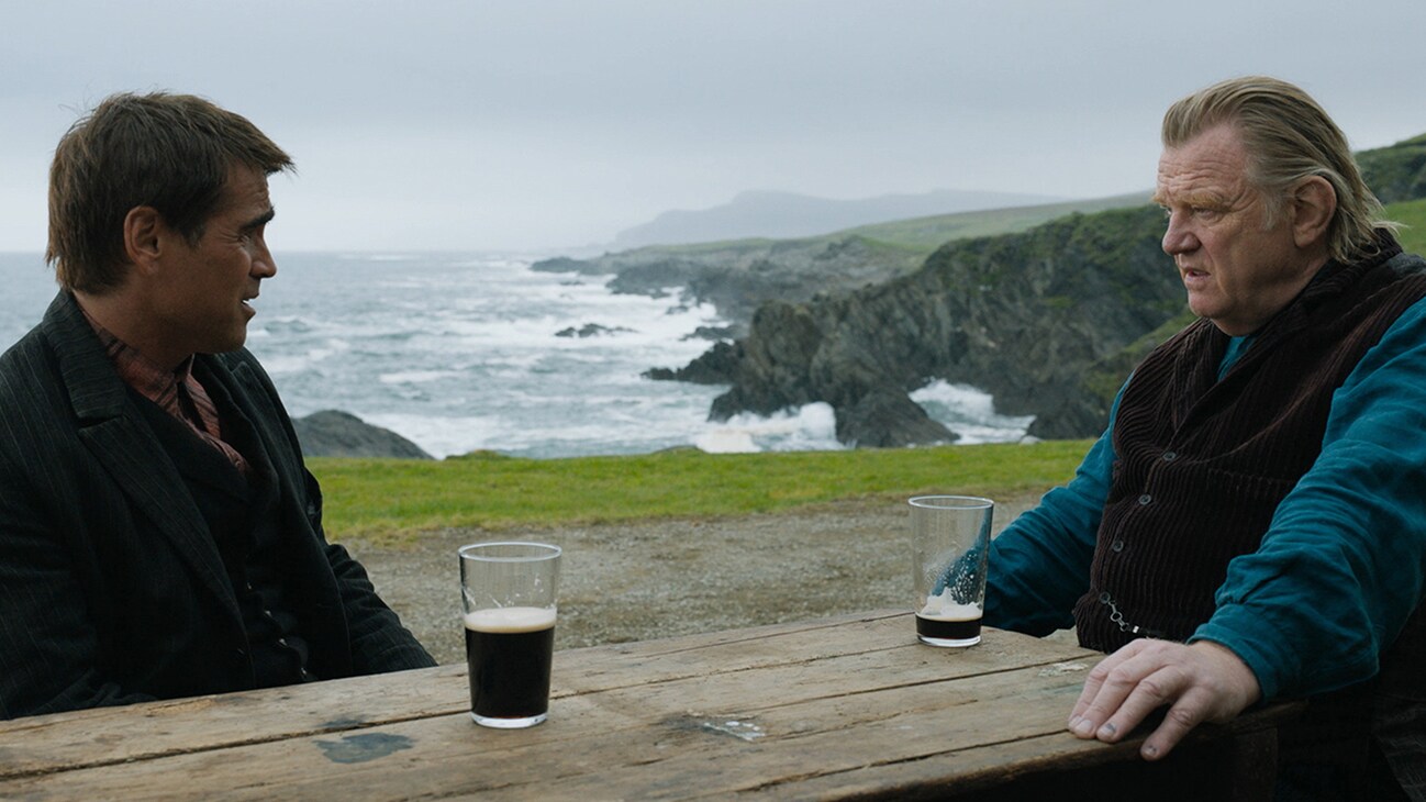 Colm Doherty (actor Brendan Gleeson) and Pádraic Súilleabháin (actor Colin Farrell) sitting outside by the water from the Searchlight Pictures movie "The Banshees of Inisherin".