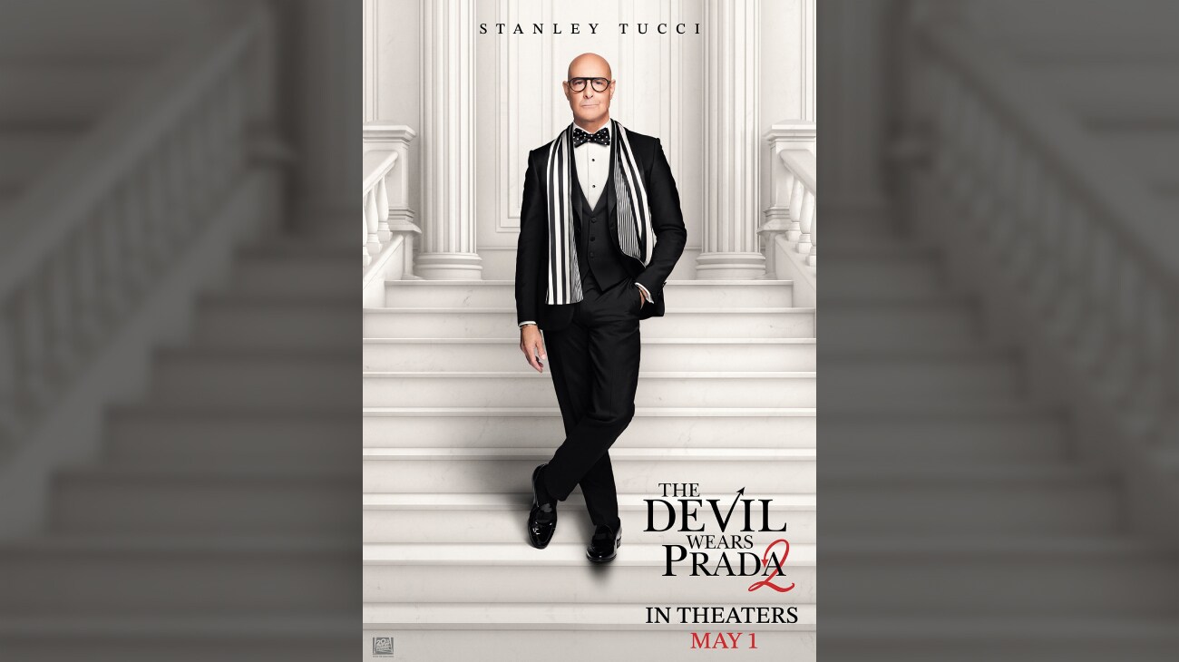 Stanley Tucci standing on a white staircase in a tuxedo with a scarf. | The Devil Wears Prada 2 | May 1 | © 2026 20th Century Studios. All Rights Reserved. | movie poster