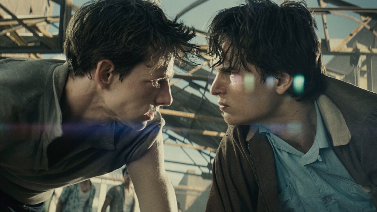 Actors Mike Faist and Ansel Elgort staring at each other with menacing looks from the 20th Century Studios movie "West Side Story".