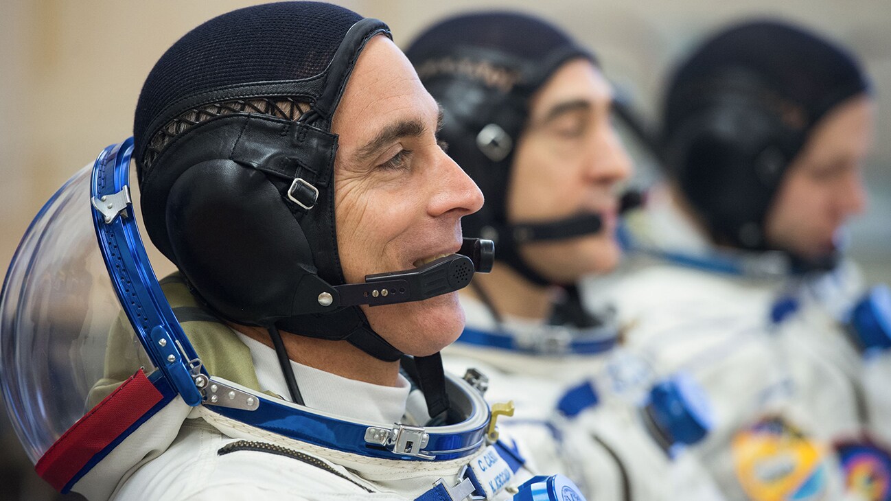 AMONG THE STARS - Expedition 63 crewmembers Chris Cassidy of NASA, left, Anatoly Ivanishin and Ivan Vagner of Roscosmos, right, talk to mission managers prior to departing for the launch pad, Thursday, April 9, 2020 at the Baikonur Cosmodrome in Kazakhstan. A few hours later, they lifted off on a Soyuz rocket for a six-and-a-half month mission on the International Space Station. (NASA/GCTC/Andrey Shelepin)  CHRIS CASSIDY