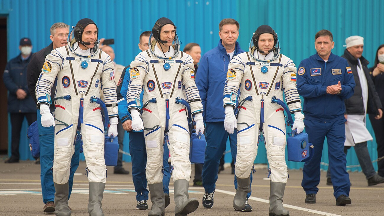 AMONG THE STARS - Expedition 63 crewmembers Chris Cassidy of NASA, left, Anatoly Ivanishin, center, and Ivan Vagner of Roscosmos, depart building 254 for the launch pad, Thursday, April 9, 2020 at the Baikonur Cosmodrome in Kazakhstan. A few hours later, they lifted off on a Soyuz rocket for a six-and-a-half month mission on the International Space Station. (NASA/GCTC/Andrey Shelepin)  CHRIS CASSIDY, ANATOLY IVANISHIN, IVAN VAGNER
