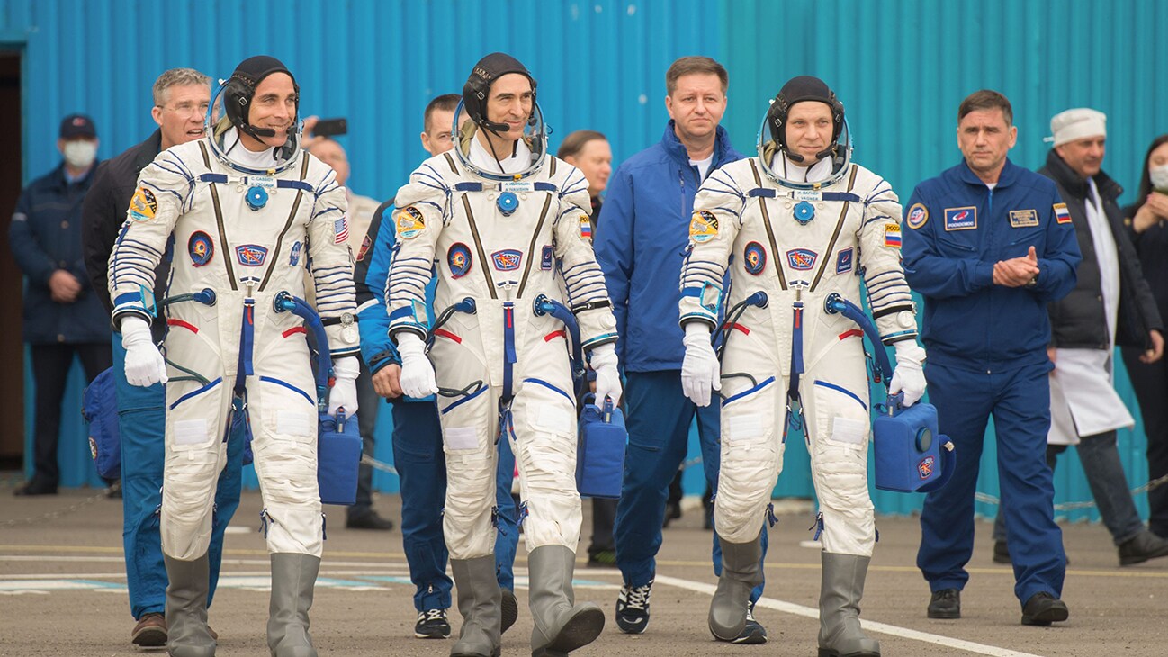 AMONG THE STARS - Expedition 63 crewmembers Chris Cassidy of NASA, left, Anatoly Ivanishin, center, and Ivan Vagner of Roscosmos, depart building 254 for the launch pad, Thursday, April 9, 2020 at the Baikonur Cosmodrome in Kazakhstan. A few hours later, they lifted off on a Soyuz rocket for a six-and-a-half month mission on the International Space Station. (NASA/GCTC/Andrey Shelepin) CHRIS CASSIDY, ANATOLY IVANISHIN, IVAN VAGNER