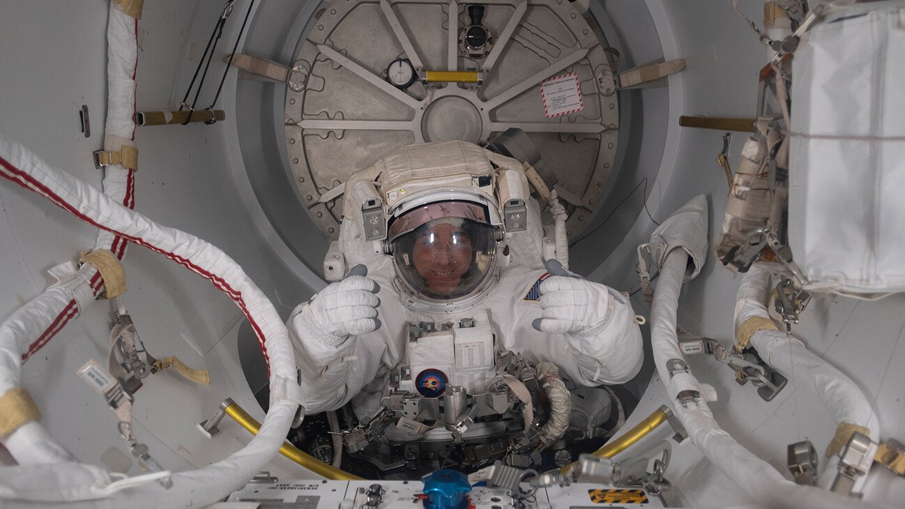 AMONG THE STARS - (July 1, 2020) - NASA astronaut and Expedition 63 Commander is pictured in his U.S. spacesuit halfway inside the crew lock portion of the Quest airlock during a spacewalk to replace batteries on the International Space Station's Starboard-6 truss structure. (NASA)  CHRIS CASSIDY