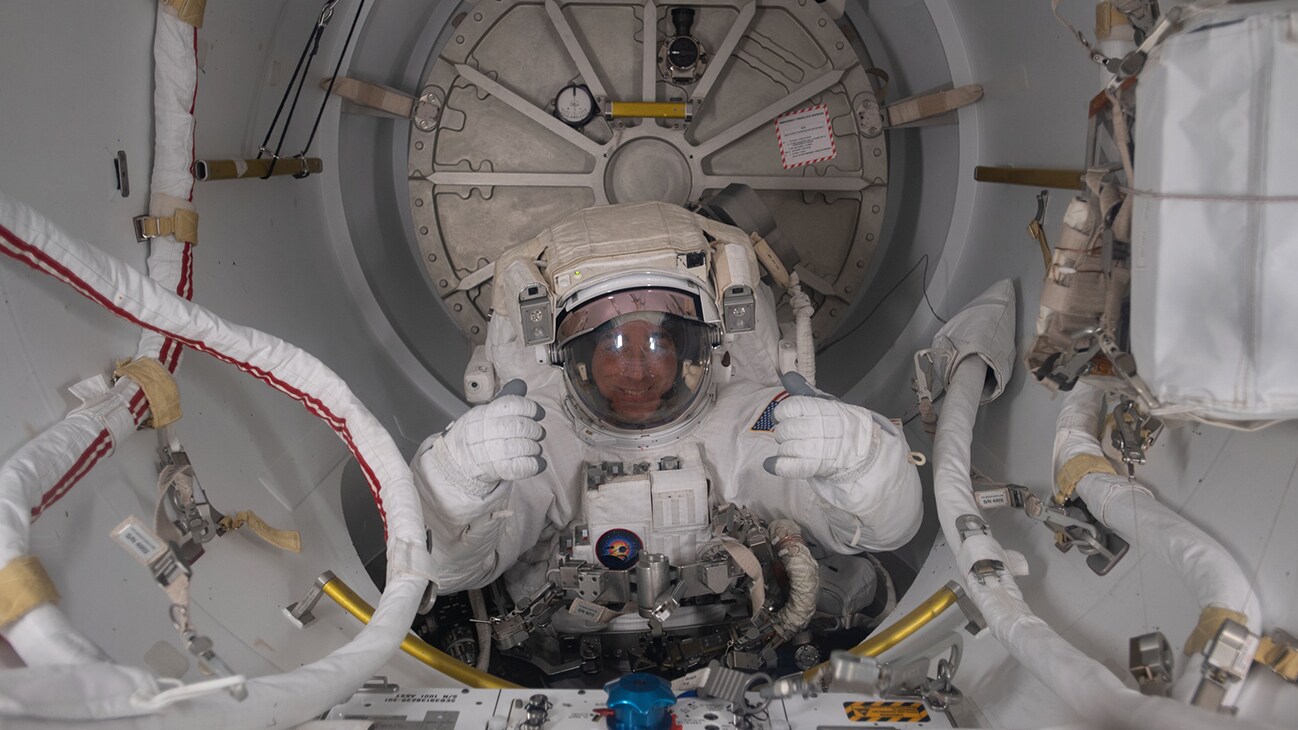 AMONG THE STARS - (July 1, 2020) - NASA astronaut and Expedition 63 Commander is pictured in his U.S. spacesuit halfway inside the crew lock portion of the Quest airlock during a spacewalk to replace batteries on the International Space Station's Starboard-6 truss structure. (NASA) CHRIS CASSIDY
