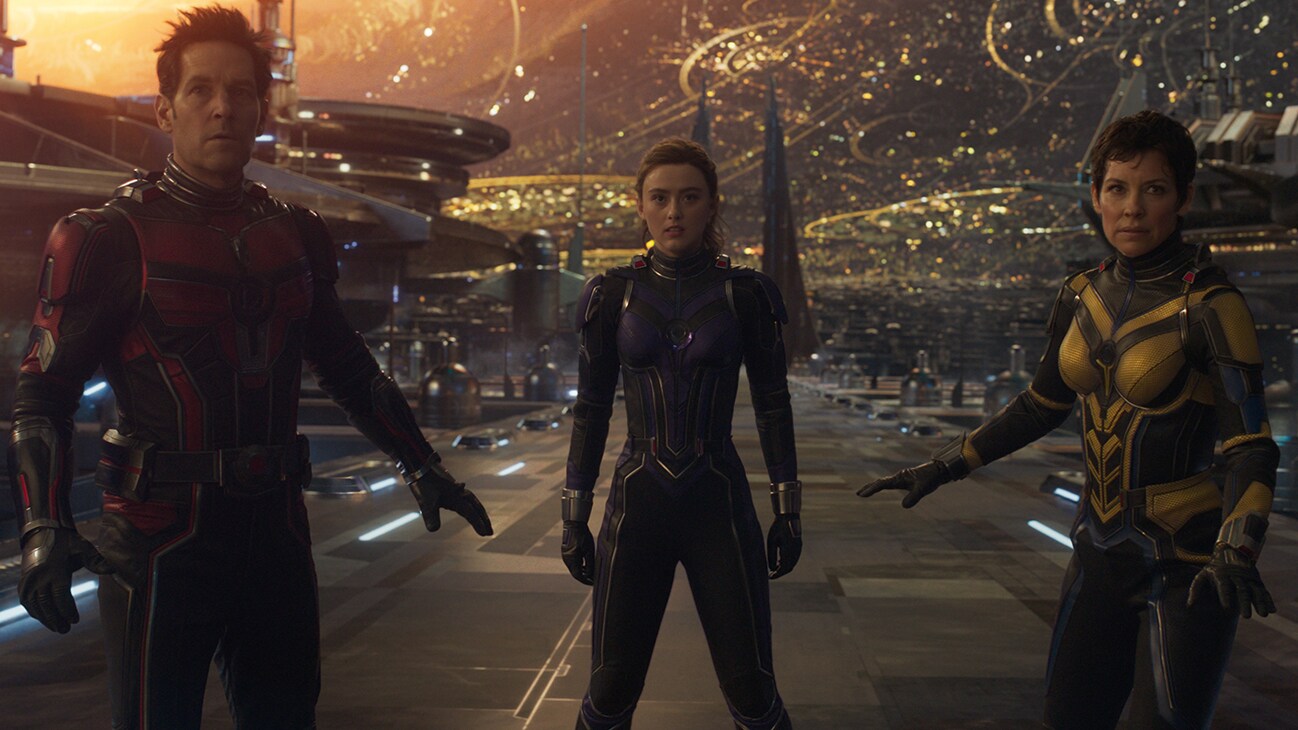 Scott Lang (actor Paul Rudd), Cassie Lang (actor Kathryn Newton), and Hope Van Dyne (actor Evangeline Lilly) standing in the middle of a street from the film "Marvel Studios' Ant-Man and the Wasp: Quantumania".