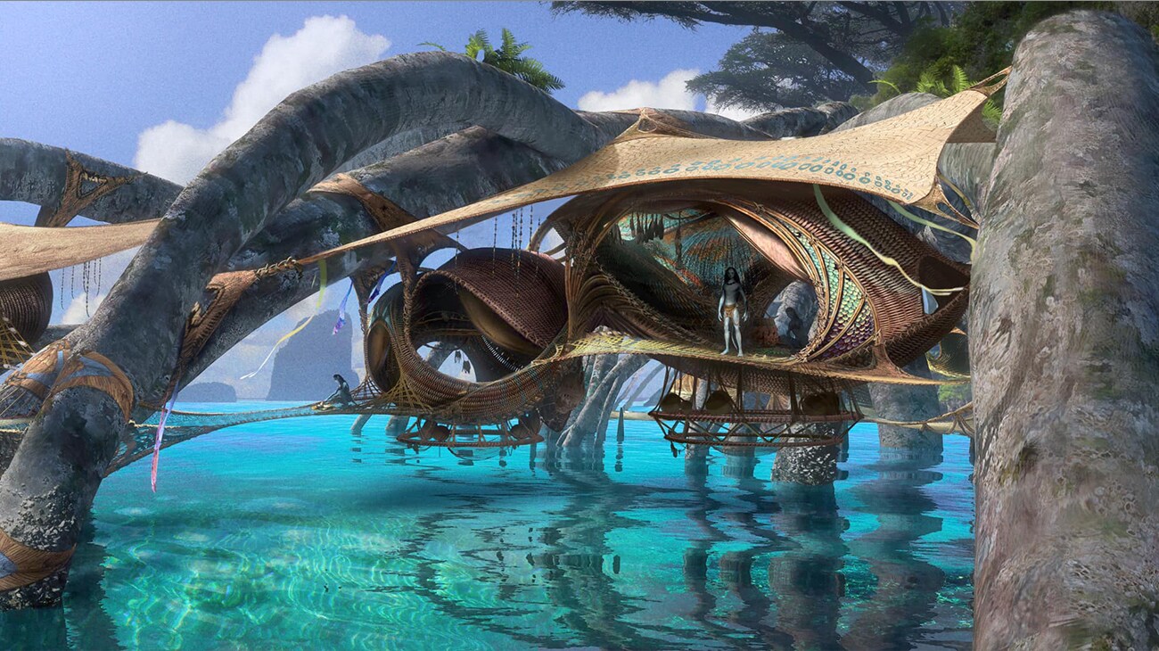 A Na'vi stands inside the woven structures of a Metkayina village, suspended above the reef.