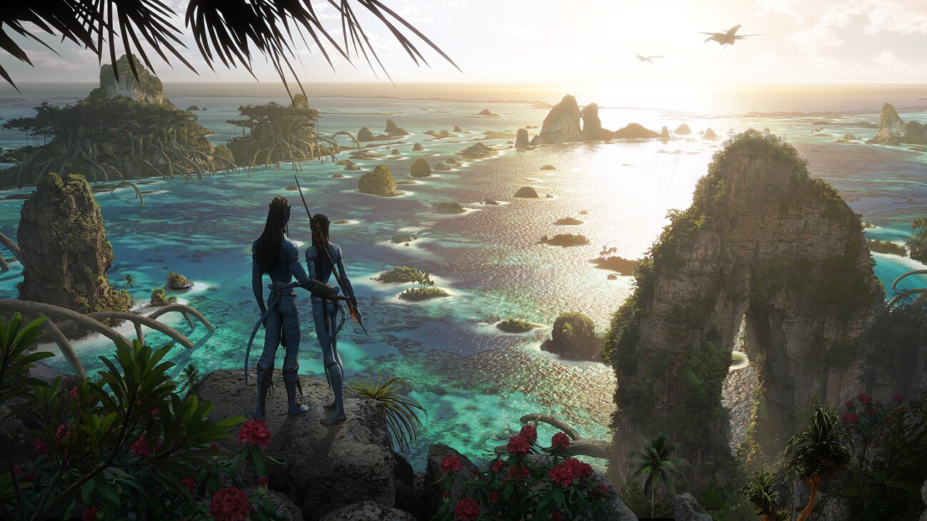 Image of two characters observing the ocean from the rock from the 20th Century Studios movie Avatar: The Way of Water.