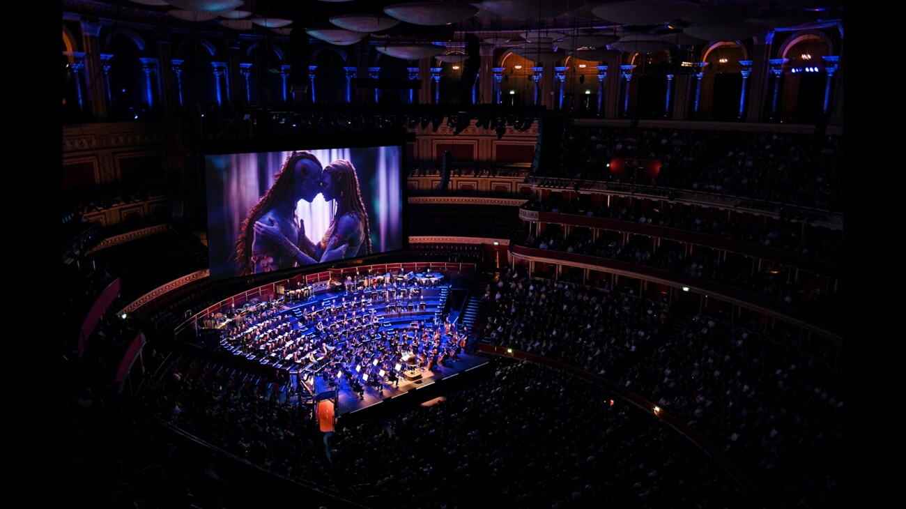 Image of a symphony and audience with characters from Avatar playing on a movie screen above.