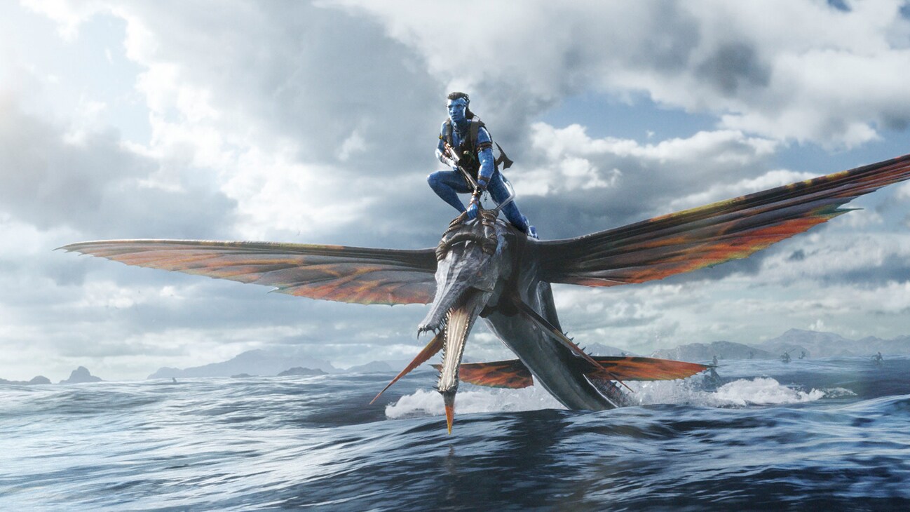 Image of a character riding on a flying sea creature from the 20th Century Studios movie Avatar: The Way of Water.