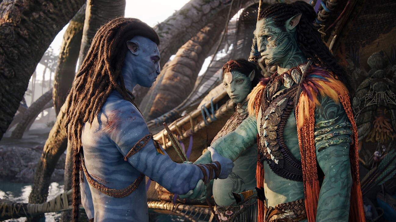 A Na'vi adult shaking hands with another Na'vi adult the 20th Century Studios movie, "Avatar: The Way of Water".
