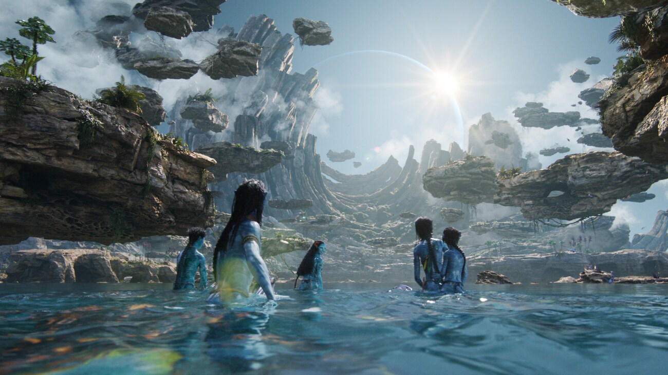 Members of the Metkayina clan gaze up at the sky from the waters of the Cove of the Ancestors.