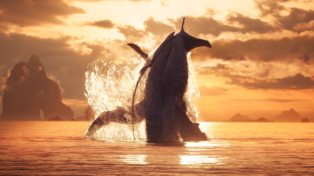 A tulkun breaches from the ocean during a sunset.