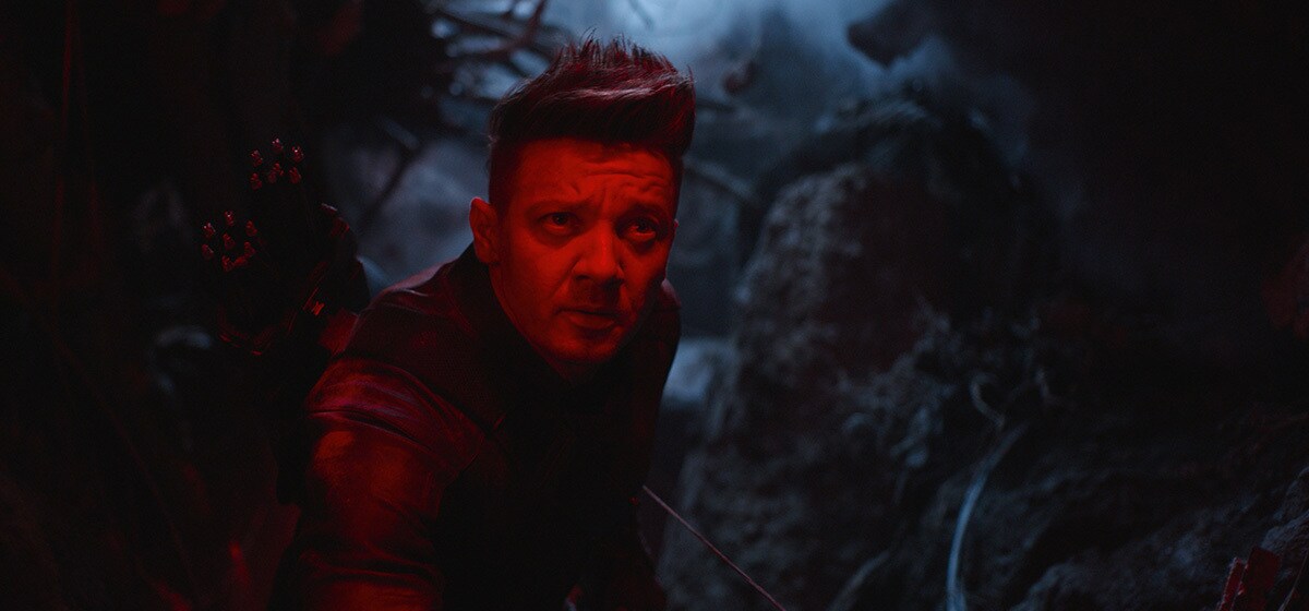 Jeremy Renner, who plays Haweye in Avengers: Endgame, cast in a red light amidst darkness