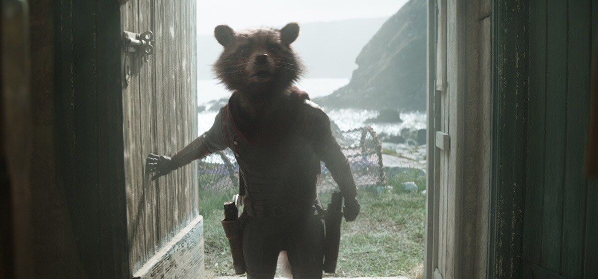 Rocket, voiced by Bradley Cooper, walking through a door in Avengers: Endgame