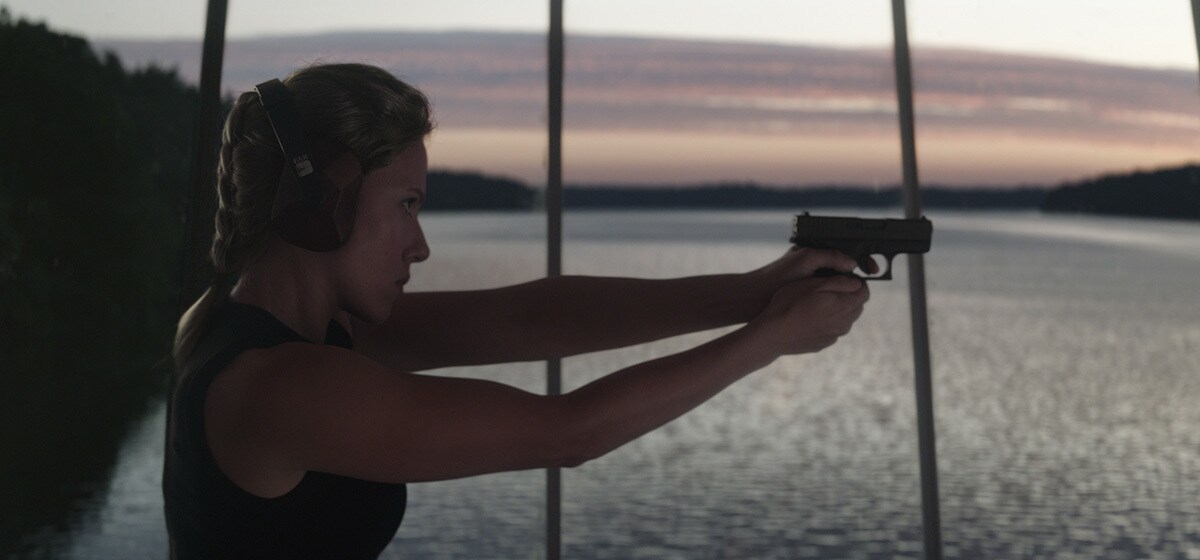 Scarlett Johansson as Natasha Romanoff/Black Widow shooting a gun in Avengers: Endgame