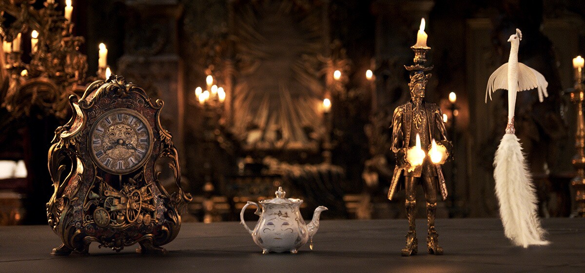 Ewan McGregor (Lumiere), Emma Thompson (Mrs. Pots), Ian McKellen (Cogsworth), and Gugu Mbatha-Raw (Plumette) in Beauty and the Beast