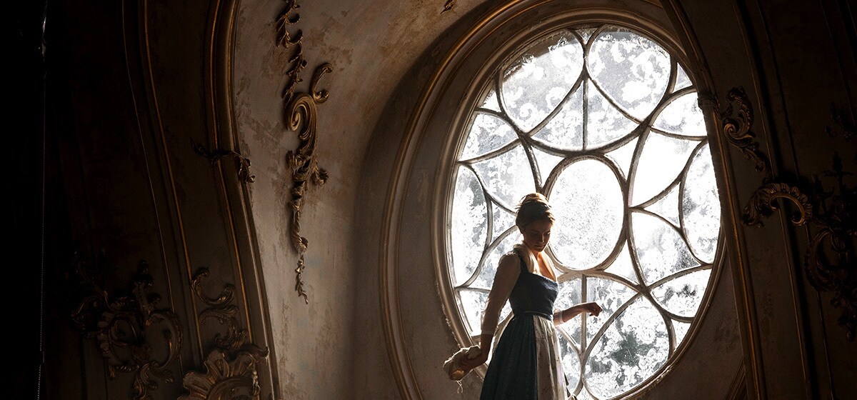 Emma Watson (Belle) cleans a large window in the castle in "Beauty and the Beast"