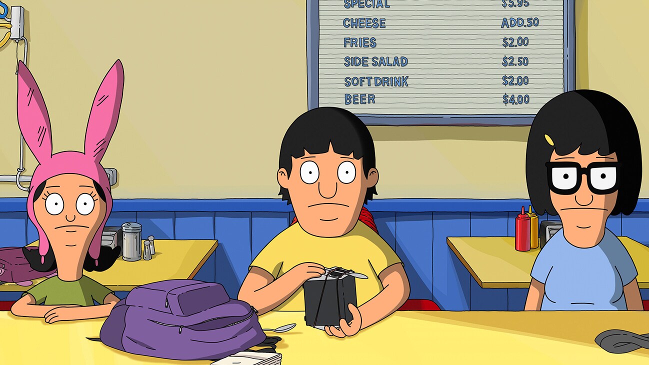 Gene Belcher (voice of Eugene Mirman), Tina Belcher (voice of Dan Mintz), and Louise Belcher (voice of Kristen Schaal) sitting at a table from the 20th Century Studios movie "The Bob's Burgers Movie".