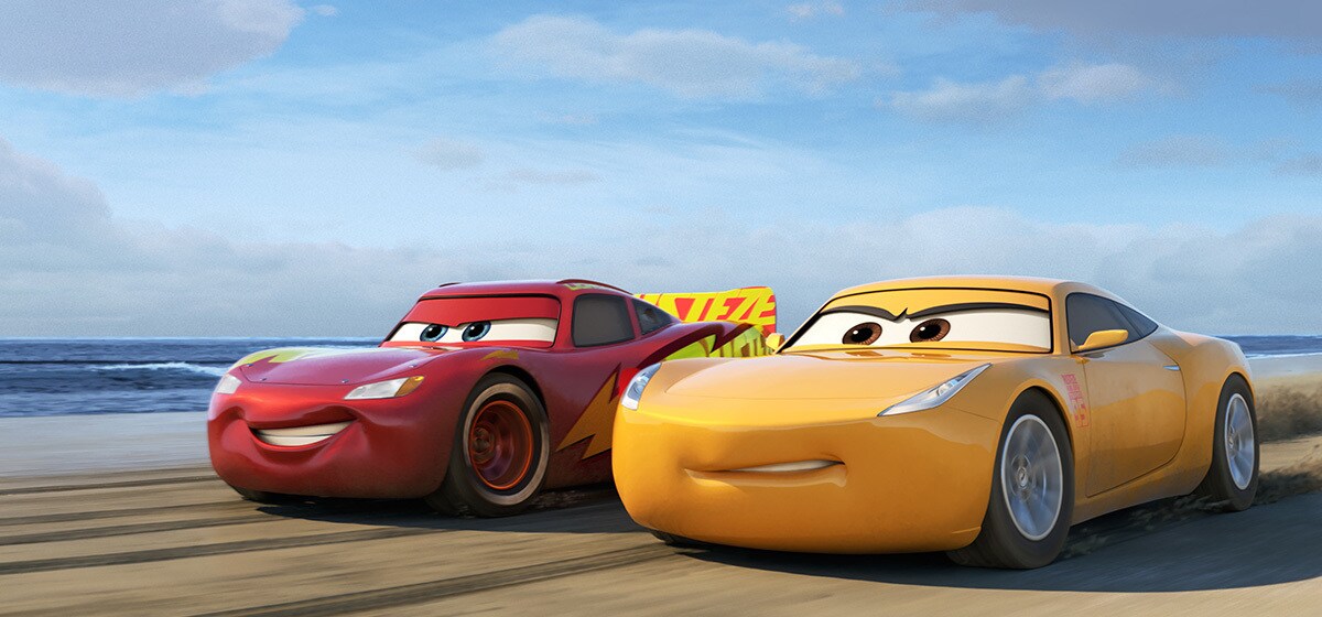 Owen Wilson as Lightning McQueen and Cristela Alonzo as Cruz Rameriez on the racetrack in Cars 3