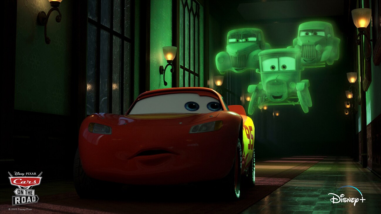 Lightning McQueen (voice of Owen Wilson) is followed by three ghost cars from the Disney+ Original series "Cars on the Road".