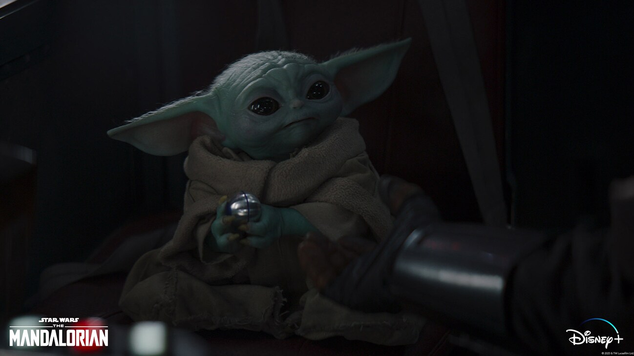 Grogu and the Mandalorian (Pedro Pascal) in Lucasfilm's THE MANDALORIAN, season two, exclusively on Disney+. © 2020 Lucasfilm Ltd. & ™. All Rights Reserved.