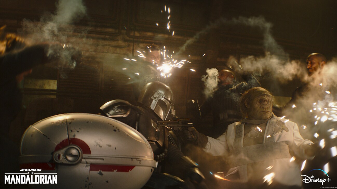 The Mandalorian (Pedro Pascal) and Gor Koresh (in background, center) in Lucasfilm's THE MANDALORIAN, season two, exclusively on Disney+. © 2020 Lucasfilm Ltd. & ™. All Rights Reserved.