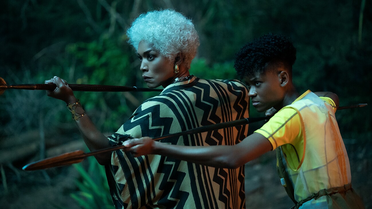 Queen Ramonda (actor Angela Bassett) and Shuri (actor Letitia Wright) stand together, armed with spears. From the film, Marvel Studios' Black Panther: Wakanda Forever.