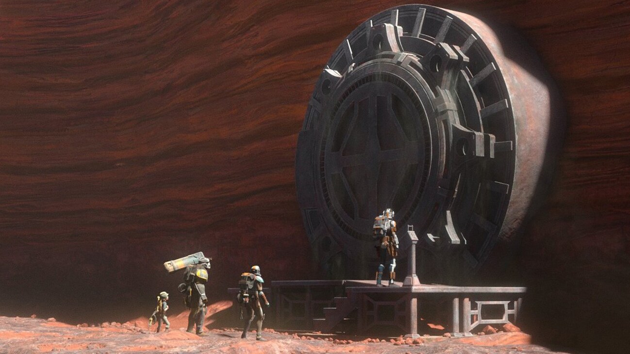 Omega, Wrecker, Hunter, and Tech in front of a large gate from the Disney+ Original series, "Star Wars: The Bad Batch" season 2, episode 9.