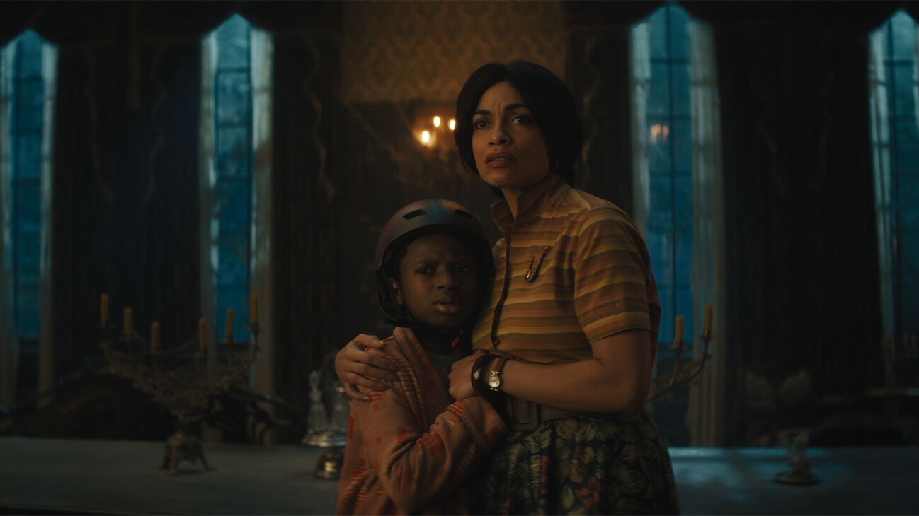 (L-R): Chase Dillon as Travis and Rosario Dawson as Gabbie in Disney's live-action HAUNTED MANSION. Photo courtesy of Disney. © 2023 Disney Enterprises, Inc. All Rights Reserved.