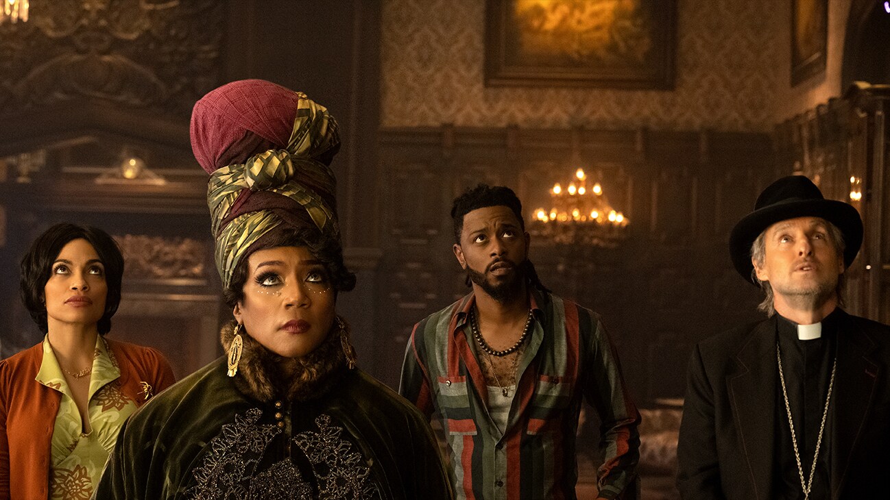 (L-R): Rosario Dawson as Gabbie, Tiffany Haddish as Harriet, LaKeith Stanfield as Ben, and Owen Wilson as Father Kent in Disney's live-action HAUNTED MANSION. Photo Jalen Marlowe. © 2023 Disney Enterprises, Inc. All Rights Reserved.	