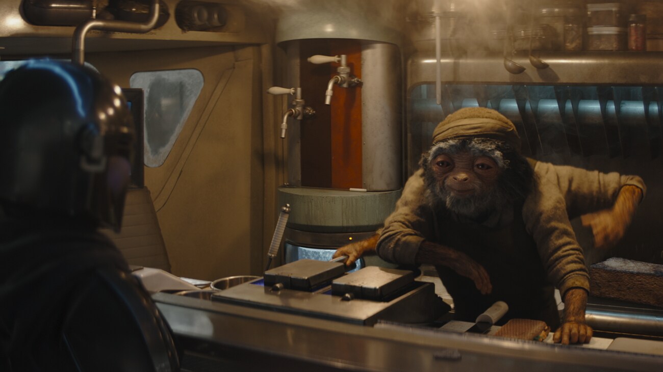 (L-R) The Mandalorian (Pedro Pascal) and Fry Cook in Lucasfilm's THE MANDALORIAN AND GROGU. Photo courtesy of Lucasfilm. © 2026 Lucasfilm Ltd™. All Rights Reserved.
