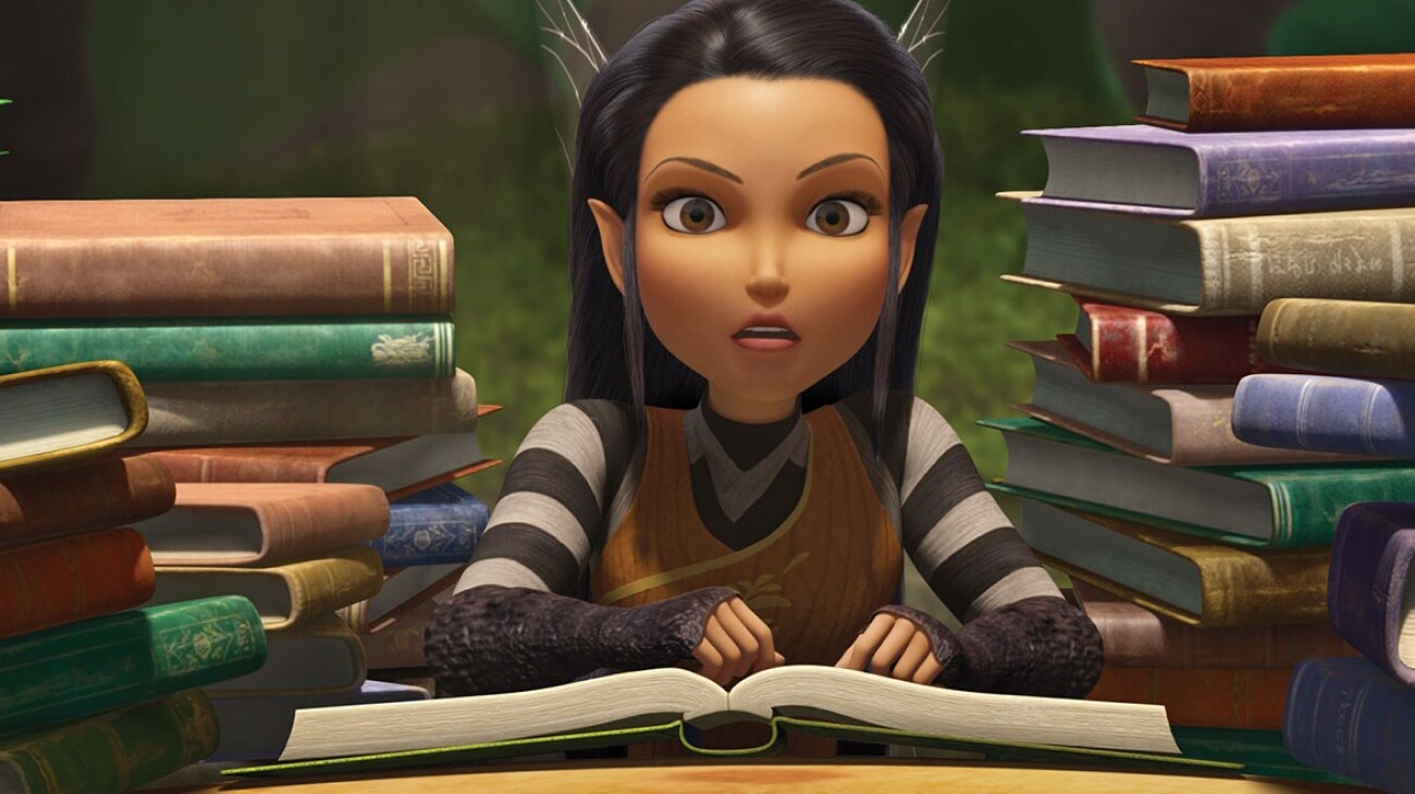 Nyx pours over her collection of books.