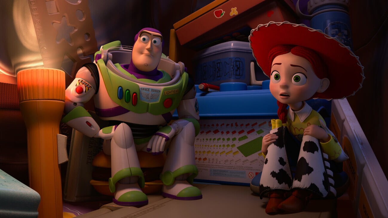 Buzz Lightyear (Tim Allen) and Jessie (Joan Cusack) sitting down and listening intently as Mr. Pricklepants tells a scary story in Toy Story of Terror! (2013).