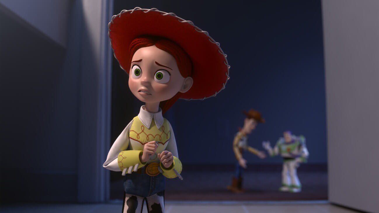 Jessie (Joan Cusack) looking worried while Sheriff Woody (Tom Hanks) and Buzz Lightyear (Tim Allen) talk in the background in Toy Story of Terror! (2013).