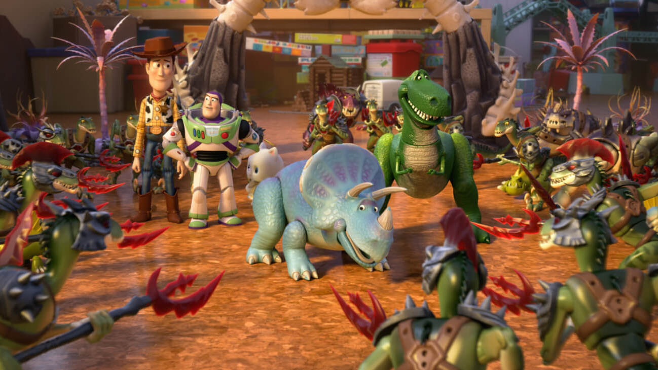 (L - R) Sheriff Woody (Tom Hanks), Buzz Lightyear (Tim Allen), Angel Kitty, Trixie (Kristen Schaal), and Rex (Wallace Shawn) encounter the Battlesaurs in Mason's playroom in Toy Story That Time Forgot (2014).