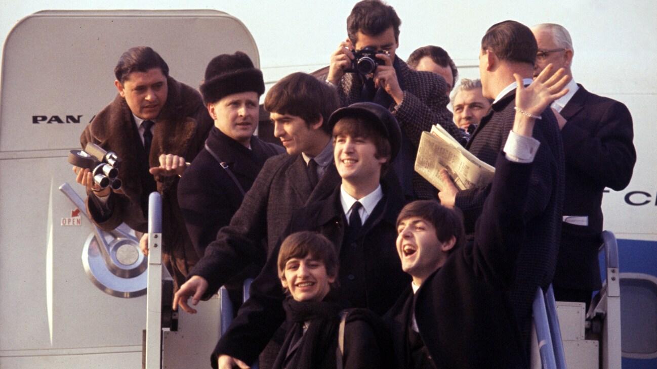 (L-R) George Harrison, Ringo Starr, John Lenon, and Paul Mccartney arriving at JFK airport in BEATLES 64'. Photo Courtesy of Apple Corps, Ltd. All Rights Reserved.