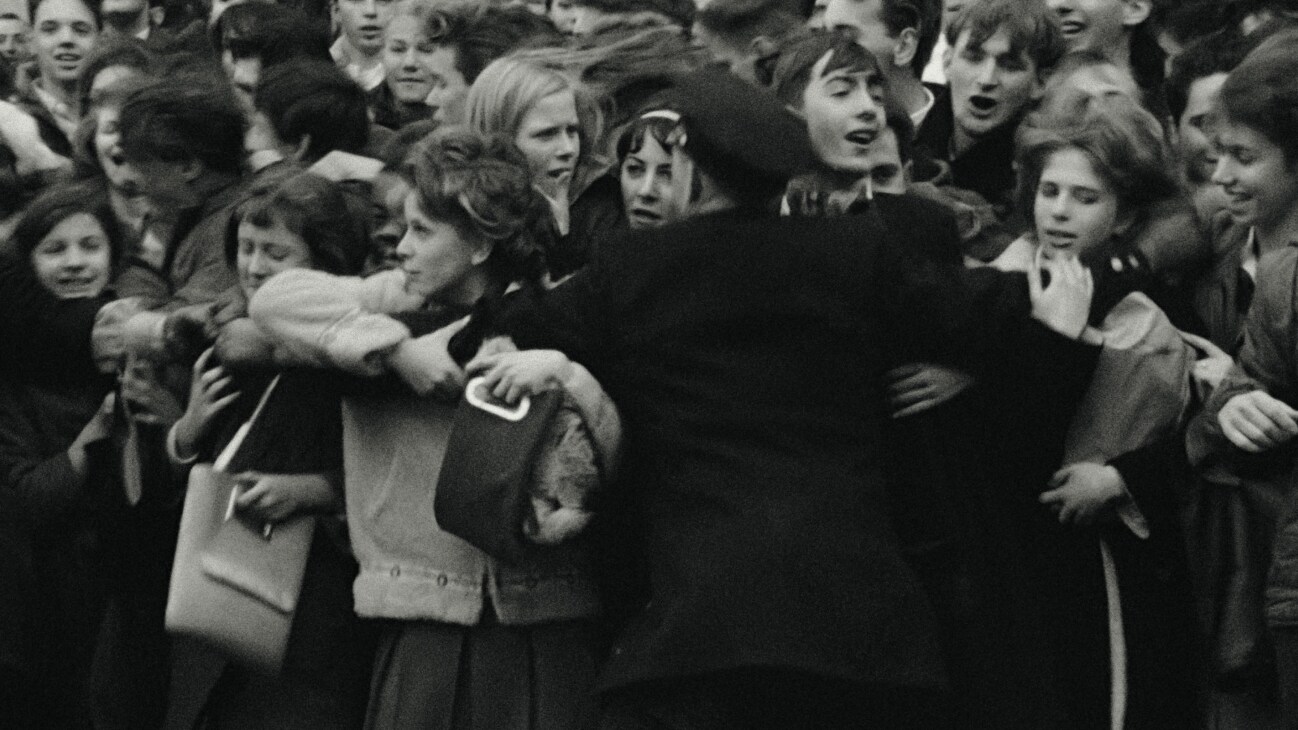 Policemen holds back fans in Disney's BEATLES '64. © 2024 Apple Corps, Ltd. All Rights Reserved.