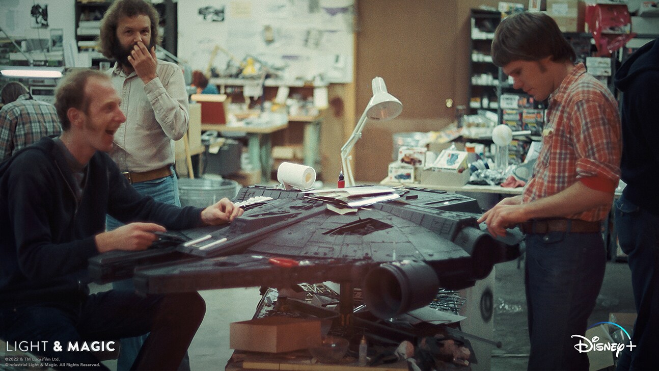 Image of several people working on the Millenium Falcon model from the Disney+ Original series, "Light & Magic". | © & ™ Lucasfilm Ltd. ©Industrial Light & Magic. All Rights Reserved.