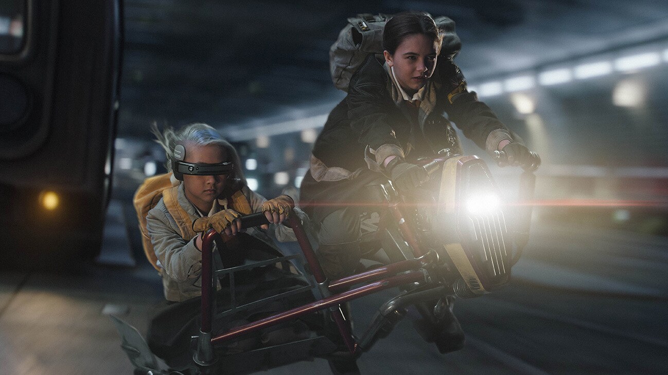 (L-R): KB (Kyriana Kratter) and Fern (Ryan Kiera Armstrong) on hoverbikes in Lucasfilm's STAR WARS: SKELETON CREW, exclusively on Disney+. Photo by Matt Kennedy. ©2024 Lucasfilm Ltd. & TM. All Rights Reserved.