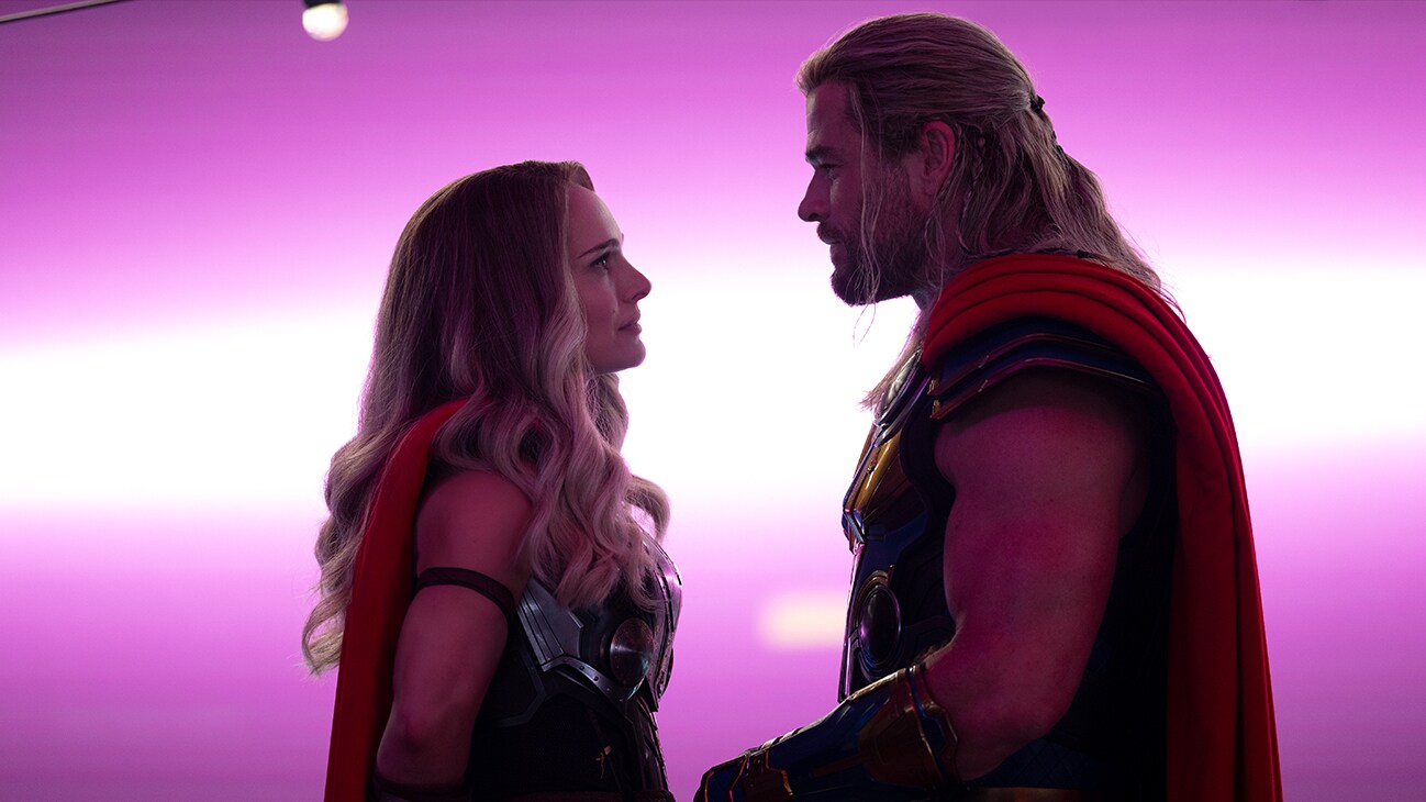 Thor (actor Chris Hemsworth) and Mighty Thor (actor Natalie Portman) gaze at each other in Marvel Studios' Thor: Love and Thunder.
