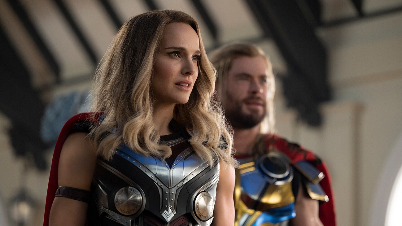 Thor (actor Chris Hemsworth) and Mighty Thor (actor Natalie Portman) stare off-screen in Marvel Studios' Thor: Love and Thunder.