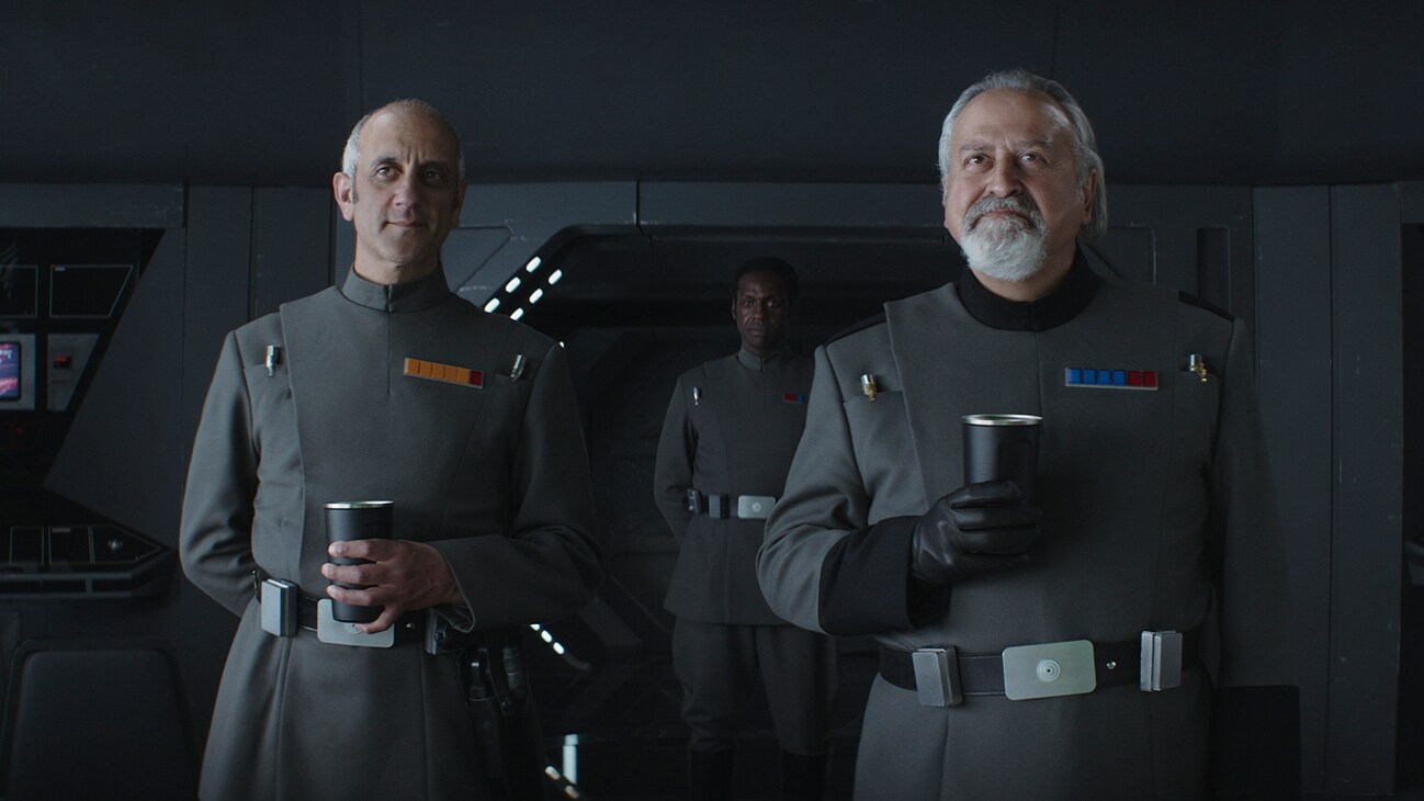 Several Imperial officers holding cups from the Disney+ Original series, "Andor."