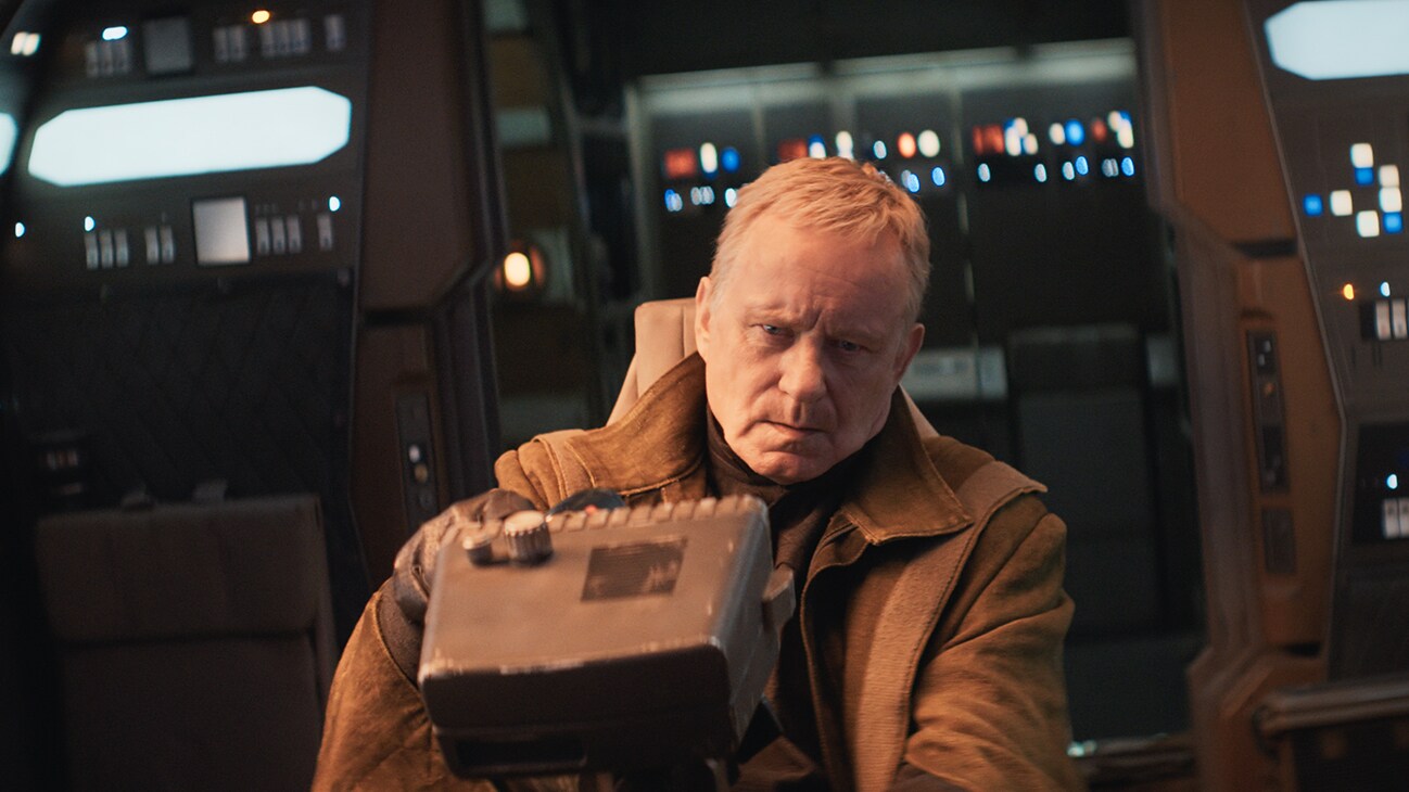 Luthen Rael (actor Stellan Skarsgård) at the controls of a vehicle from the Disney+ Original series, "Andor."