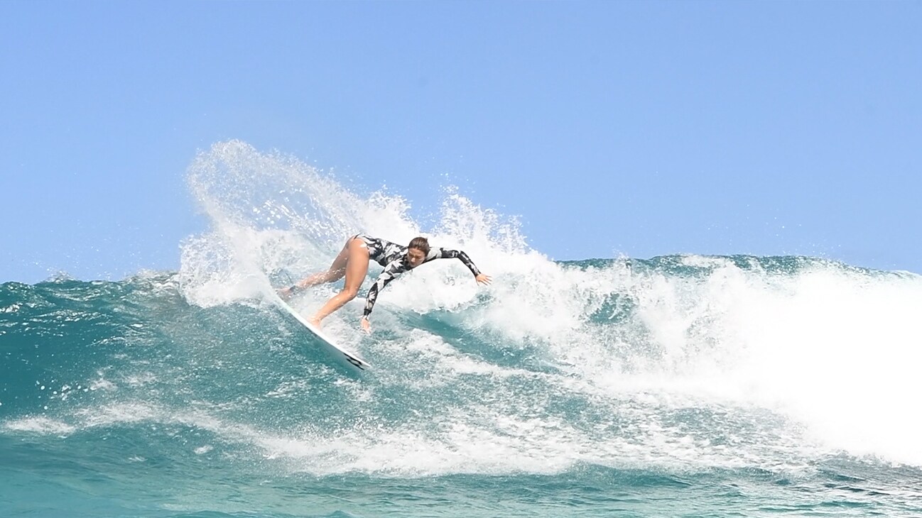 A surfer rides a wave.