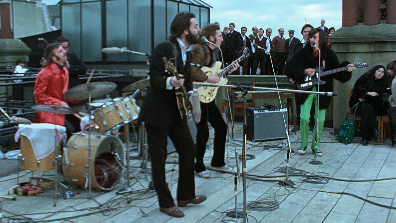 The Beatles performing on a rooftop from the Disney+ Original docuseries "The Beatles: Get Back".